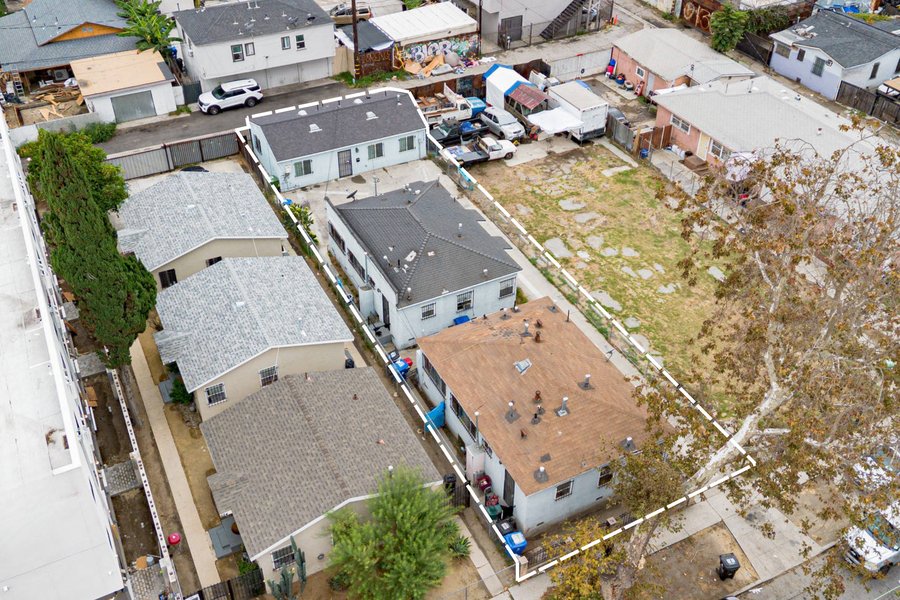 Aerial drone photo of 620 E 79th St with property lines outlined, single-story five-unit South LA multifamily with four-plex and rear ADU